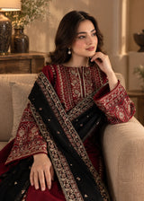 Khizra Artstyle crimson embroidered 3-piece suit — Garnet Grace design, seated side profile showing the embroidered neckline and sleeve