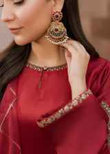 Khizra Artstyle cherry-red embroidered 3-piece suit — Gul Naaz design, close-up of the jhumka earring and embroidered neckline, adjusting the earring