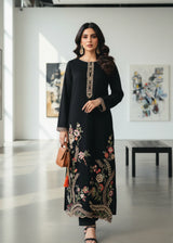 Khizra Artstyle black embroidered 2-piece suit — Hina design, full front lifestyle view in a gallery setting holding a tan handbag